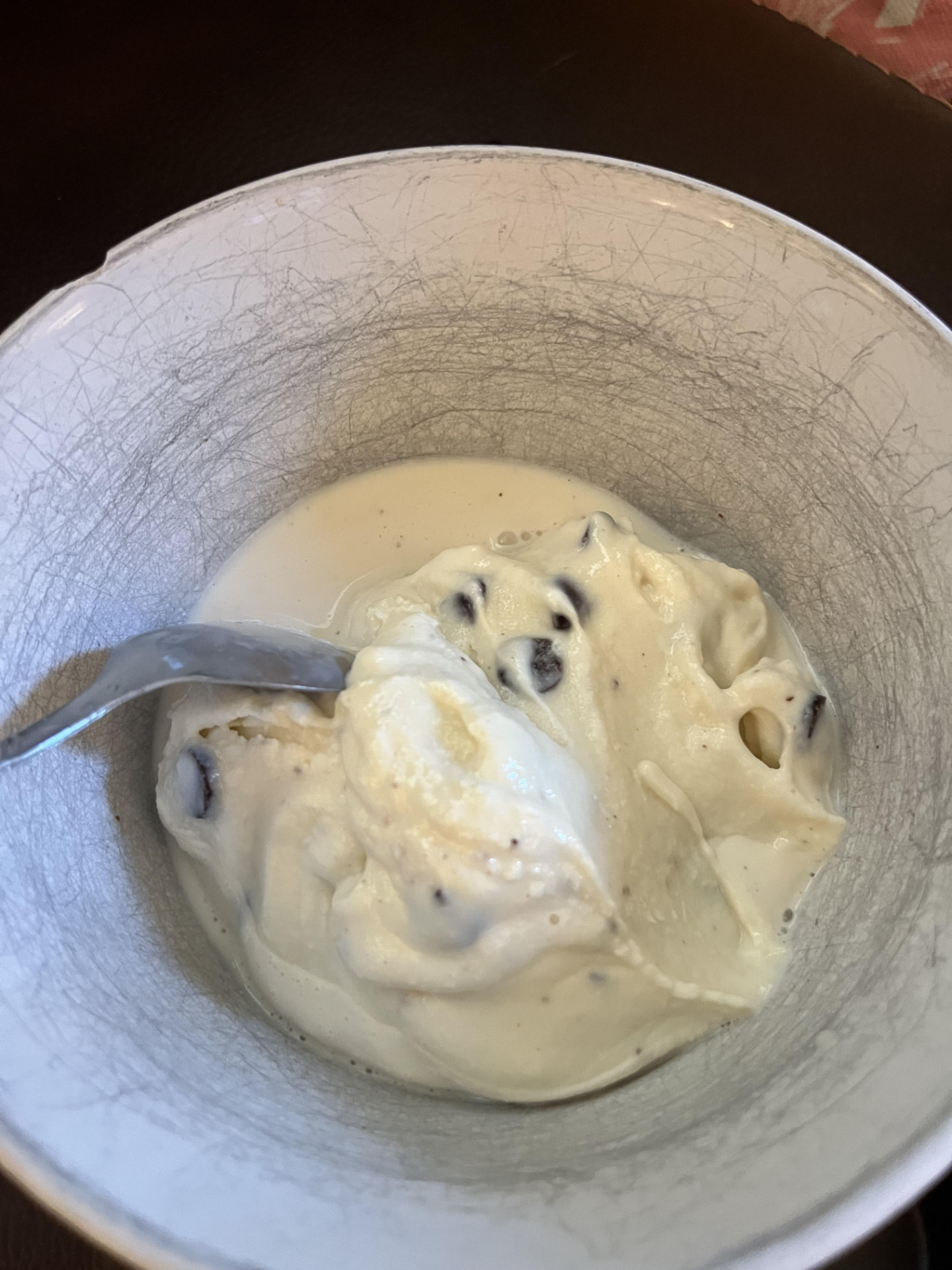 Photograph  of a melted gelato mixture showing free water separation after high-shear churning